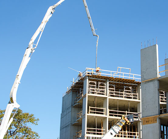 Concrete pumping boom placing concrete for a high rise building | Commercial Services